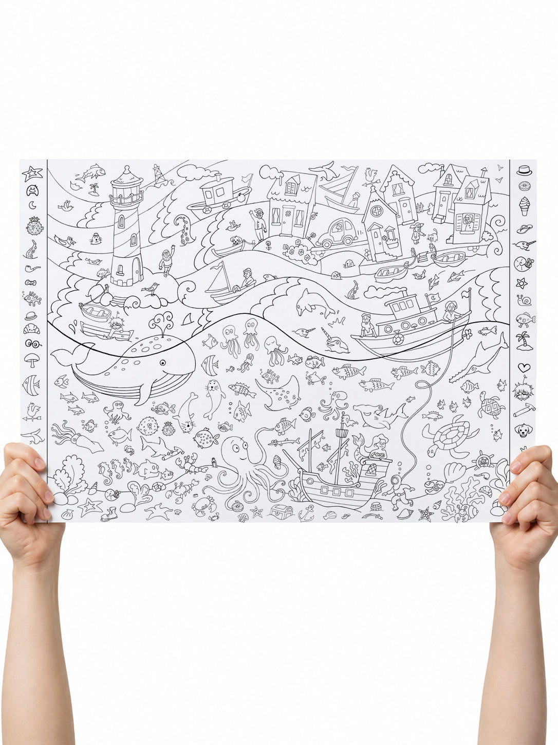  Hands holding up the full Under the Sea coloring poster, showing every scene — boats, whales, lighthouse, shipwreck, mermaid, diver — and the find-it borders ready to color.